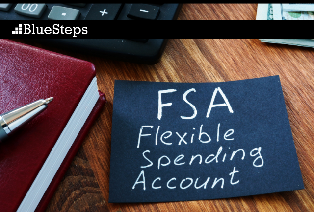 Desk with a sticky note with the words FSA - Flexible Spending Account